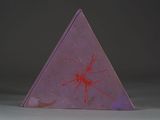 a purple triangular box with a red design on it