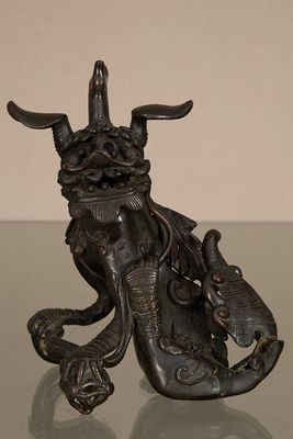 une statue en bronze représentant un taureau avec un sac sur le dos