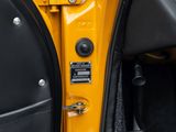 a close up of a door handle on a yellow car