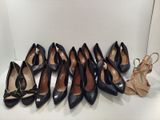nine pairs of women ' s shoes are lined up on a shelf
