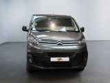 the citrole is parked in the showroom with its lights on