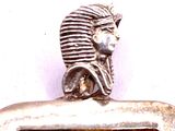 a silver clock with a picture of an egyptian man on it