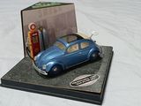 a blue toy car sitting on top of a book