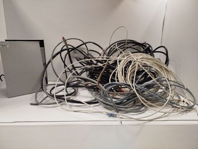 a pile of wires and wires on a white shelf