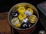 a bucket full of beer bottle caps sitting on a table