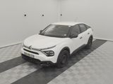 the white car is parked in the garage on the checkered floor