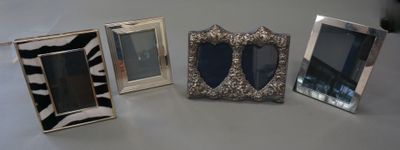 three picture frames sitting next to each other on a table