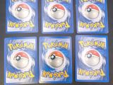 six pokemon keychains are sitting on top of a table