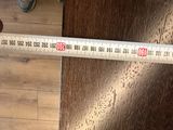 a measuring tape that is on the floor of a room