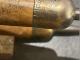 a close up of a metal object with a wooden handle