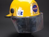 yellow hard hat with a helmet attached to it on a black surface
