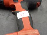 a corded drill that is laying on the ground