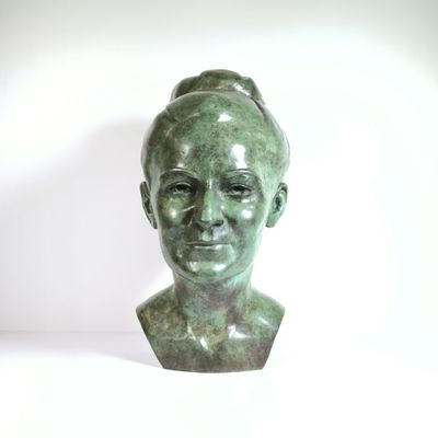 sculpture of a woman ' s head with a bun on her head