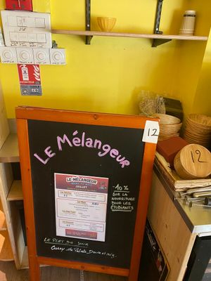 a chalk board with a menu on it in a kitchen