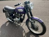 a purple motorcycle that is parked in the parking lot