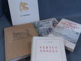 several books are sitting on a blue cloth covered surface