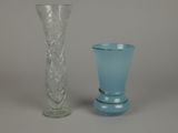 two glass vases sitting next to each other on a table