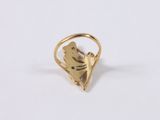 a close up of a gold ring with a bird on it