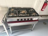 a gas stove with a fire extinguisor on top of it