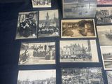 several old black and white photographs of people and buildings on a table