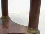 a small wooden table with two candles on top of it