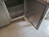 a small oven that is sitting in the corner of a kitchen