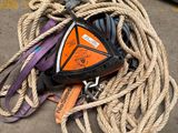 a pile of rope on the ground next to a piece of equipment