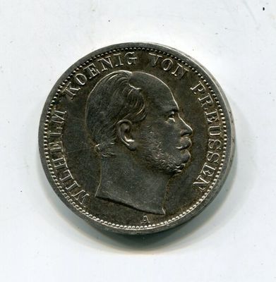 Gros plan sur une pièce de monnaie portant le visage d'un homme