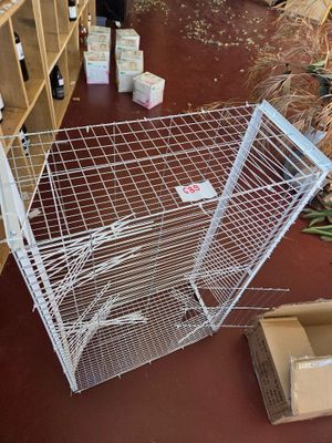 a cage that is sitting on the floor in a room