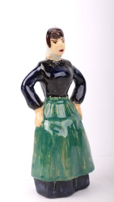 a figurine of a woman wearing a green skirt