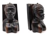 pair of wooden bookends of a woman ' s head and a woman ' s head