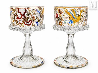 two wine glasses that are sitting next to each other