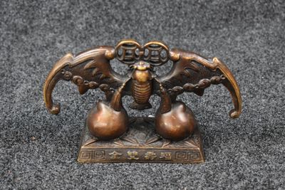 a close up of a bronze figurine of two birds on a table