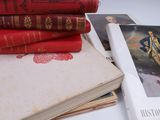 several books are stacked on top of each other on a table