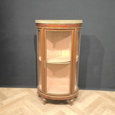 an image of a corner cabinet in the corner of a room