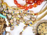 a lot of different necklaces and bracelets on a table