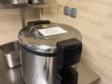 stainless steel counter top with pots and pans on top of it