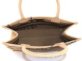 the inside of a beige purse with a handle and handles