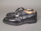 they are two pairs of black shoes with laces on them