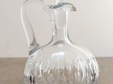 a clear glass decanter sitting on a table