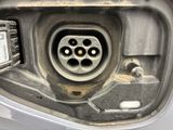 a close up of a car ' s fuel tank with a plug attached to it