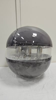 a glass ball with water in it sitting on a table