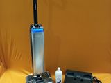 a vacuum that is sitting on a table next to a laptop