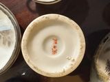many cups and saucers sitting on a table