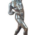 bronze statue of a man holding a tennis racket on a marble base