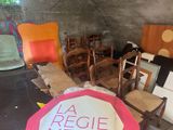 several chairs and a table in a room with a sign on it