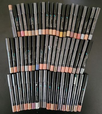 a stack of makeup pencils sitting on top of each other