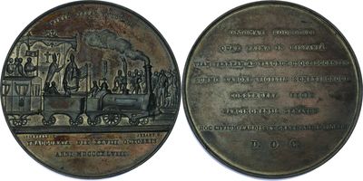 two medals that are on display on a white surface