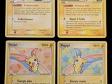 four pokemon cards with different designs on them on a black background