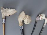 several different types of walking sticks are lined up on a gray surface
